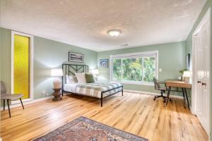 a bedroom with a bed and a desk and a window at Spacious River Cabin - Hot Tub - Sleeps 8 in Rhododendron