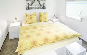 a bedroom with a yellow bedspread and yellow pillows at Cozy Home In Schwerin With Wifi in Wittenförden