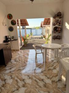 a dining room with a table and a view of the ocean at Canto das Praieiras - Porto de Sauípe, Rio & Mar in Porto de Sauipe