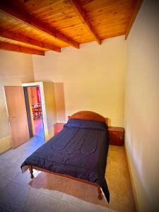 a bedroom with a bed in the corner of a room at Koonex in Los Reartes +6 photos
