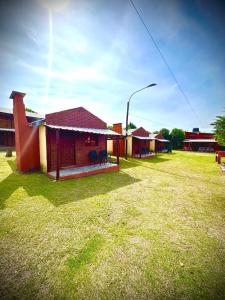 a group of buildings in a field with a street light at Koonex in Los Reartes