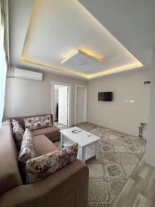 a living room with a couch and a table at Maraş Blue Life Otel in Kahramanmaras