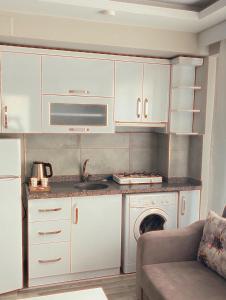 a kitchen with white cabinets and a stove at Maraş Blue Life Otel in Kahramanmaras
