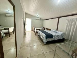 a bedroom with two beds and a window in it at Pousada da Cia in Blumenau