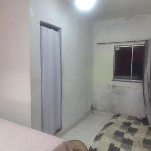 a bedroom with a window and a bed in it at Casa da D Luiza in Belém