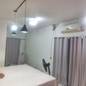 a bedroom with a bed and a shower curtain at Casa da D Luiza in Belém +1 photo