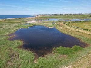 an aerial view of a small pool of water in a field at 8 person holiday home in Hurup Thy-By Traum in Sindrup