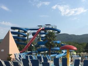 a water slide in a water park with blue chairs at L' Alcova Del Conte in Dragoni