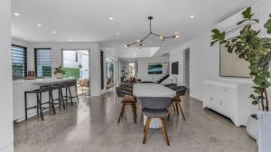 a kitchen and living room with a table and chairs at Solara in Kingscliff