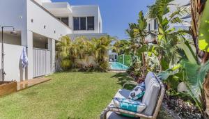 a backyard with a couch and a pool at Solara in Kingscliff