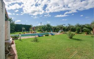 a backyard with a swimming pool and a grass yard at 2 Bedroom Beautiful Apartment In Querceta in Querceta +20 photos