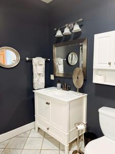 a bathroom with a white sink and a mirror at 12 Min Drive to Windham Mountain w- HOT TUB! in Durham