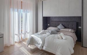 a white bedroom with a large bed with white sheets at Nice Apartment In Montevarchi With Wifi in Montevarchi