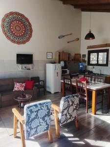 a living room with a table and chairs at A Casa Amarela - conforto e tranquilidade próximo ao mar in Balneário Gaivotas