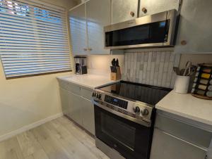 a kitchen with a stove and a microwave at Old Town Views Just Steps to Main Street and Park City Mountain for Skiing, Hiking, Biking in Park City +26 photos