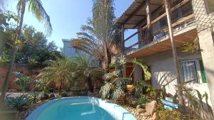 uma casa com piscina em frente a um prédio em Pousada Villa da Nascente em Florianópolis