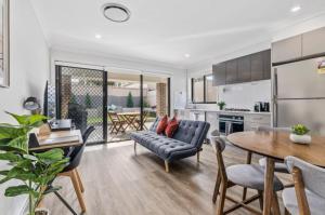 a kitchen and living room with a couch and a table at The Stayover Unit 2 - Your Wine Country Base in North Rothbury