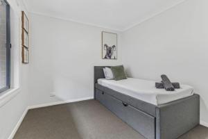a bedroom with a bed in the corner of a room at The Stayover Unit 2 - Your Wine Country Base in North Rothbury