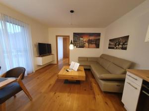 a living room with a couch and a coffee table at Galsterberg in Gröbming