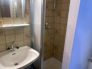 a bathroom with a sink and a shower at Landhaus am Waldrand in Oberndorf in Tirol +20 photos