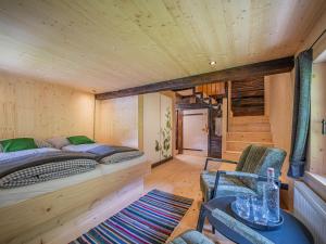 a bedroom with a bed and a table and chairs at Raneburg 4 Almhaus in Matrei in Osttirol +46 photos