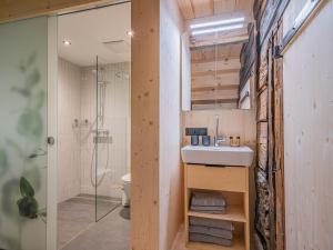 a bathroom with a sink and a shower at Raneburg 4 Almhaus in Matrei in Osttirol
