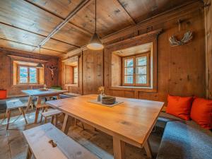 a dining room with wooden walls and a wooden table at Raneburg 4 Almhaus in Matrei in Osttirol