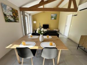a dining room with a wooden table and chairs at Westhinder II H18 in Witte Burg