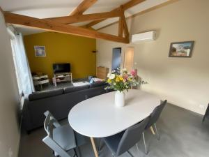 a living room with a table and a couch at Westhinder II H9 in Witte Burg +7 photos