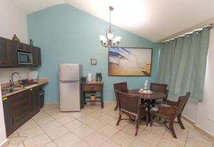 a kitchen with a table and a refrigerator at Costa Bonita Private Villas in Culebra
