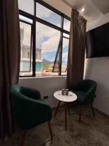 a room with two chairs and a table and a window at Hotel San Francisco in Tarapoto +17 photos