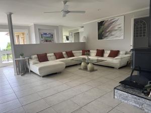 a living room with a couch and a table at Casa Serena Tamborine Mountain in Mount Tamborine