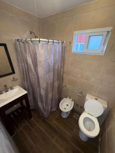 a bathroom with a toilet and a sink at Hotel&Vermú AREIA a metros del mar in Mar del Plata
