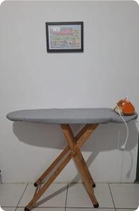 a ping pong table with a ping paddle on top at Cozinha e Lavadora Compartilhadas Qto e Wc privativos in São Luís