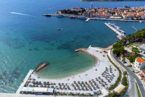 an aerial view of a beach with umbrellas at Double Room Banjol 11716b in Rab