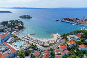 an aerial view of a resort and the ocean at Apartments and rooms by the sea Rab - 12616 in Rab