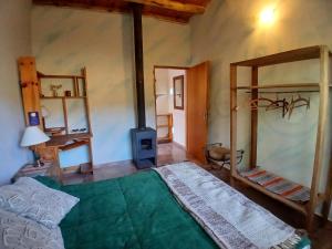 a bedroom with a bed and a stove in it at Dejavú in San Marcos Sierras