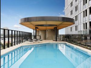 a swimming pool on top of a building at Deluxe apartments in the heart of South Melbourne in Melbourne