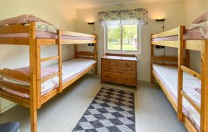 two bunk beds in a room with a window at 2 Bedroom Nice Home In Byxelkrok in Byxelkrok +2 photos