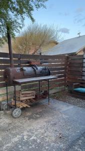 a bench sitting next to a wooden fence at Cabaña "House" in El Chalten