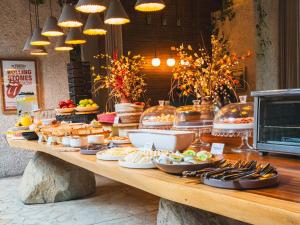 a buffet of food on a table in a restaurant at Hashtag 98 Hotel By Jalo in Medellín