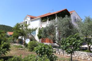 a large white house with trees in front of it at Apartment Ston 10226a in Mali Ston