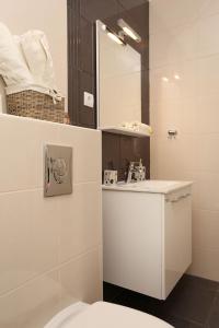 a bathroom with a toilet and a sink and a mirror at Apartment Ston 10226a in Mali Ston