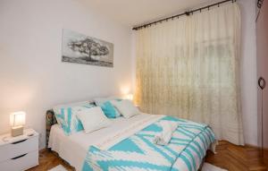 a bedroom with a bed with blue and white sheets at Family friendly house with a swimming pool Grab, Zagora - 15208 in Grab