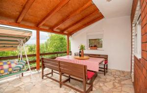 a porch with a table and chairs and a swing at Family friendly house with a swimming pool Grab, Zagora - 15208 in Grab