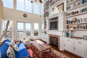 a living room with a fireplace and a tv at Breakers Pointe in Galveston
