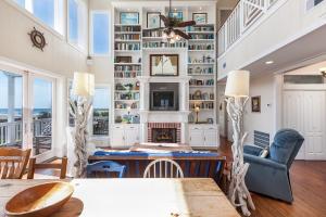 a living room with a fireplace and a table at Breakers Pointe in Galveston