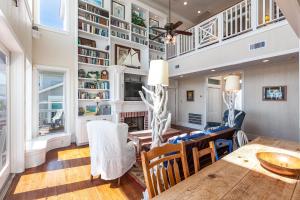 a living room with a table and chairs and a fireplace at Breakers Pointe in Galveston