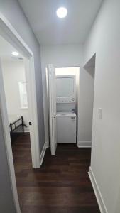 a hallway with a white refrigerator in a house at Bluehouse in East Chicago +1 photo