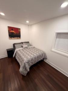 a bedroom with a bed in a white room at Bluehouse in East Chicago